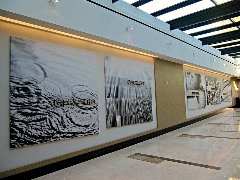 Long run of printed panels along an interior corridor