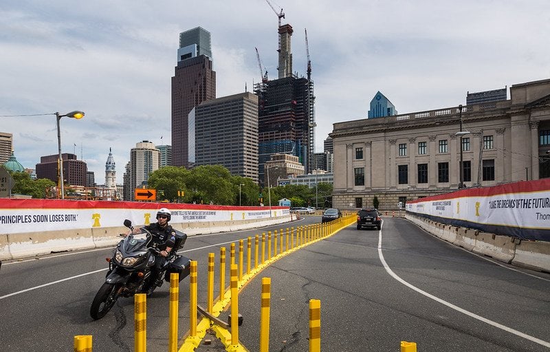 Printed banners fixed along a highway fence line