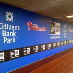 Printed wall graphic running the length of a stadium concourse
