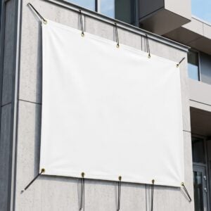 Blank vinyl banner with brass grommets hanging on a building exterior