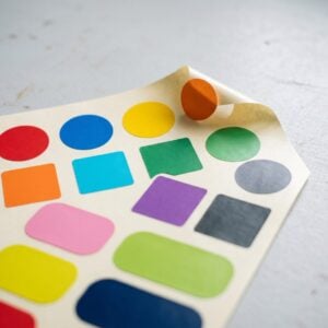 Sheet of blank die-cut vinyl decals on backing paper
