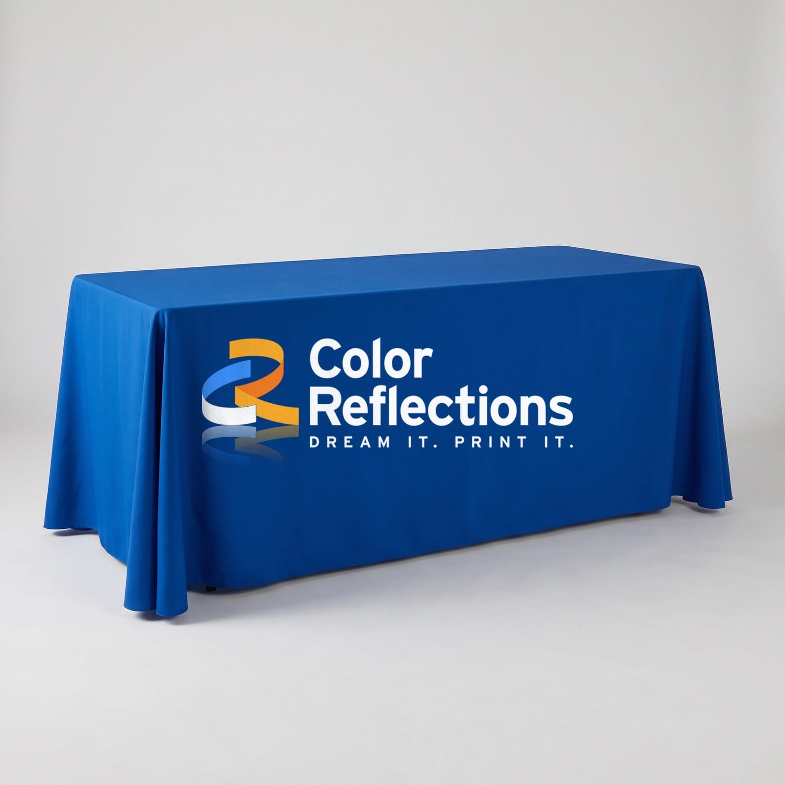 Royal blue 8ft full table throw printed with the Color Reflections logo in white on the front panel, on a trade show table