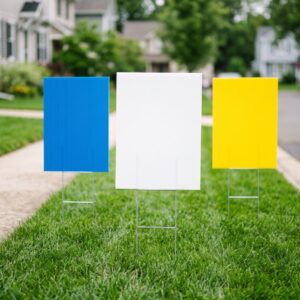 Blank corrugated plastic yard signs on metal H-stakes in grass