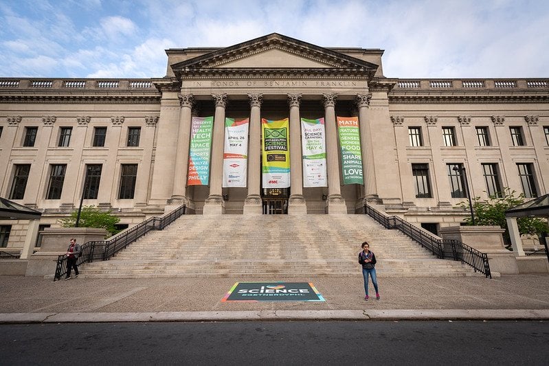 Printed banners hung across a museum building frontage